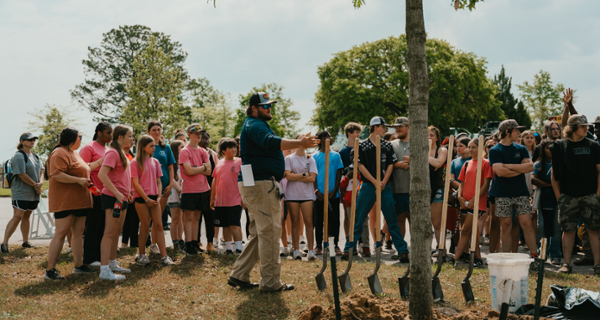 MGA grounds manager Tyler Austin works with Future Farmers of America (FFA) student volunteers.
